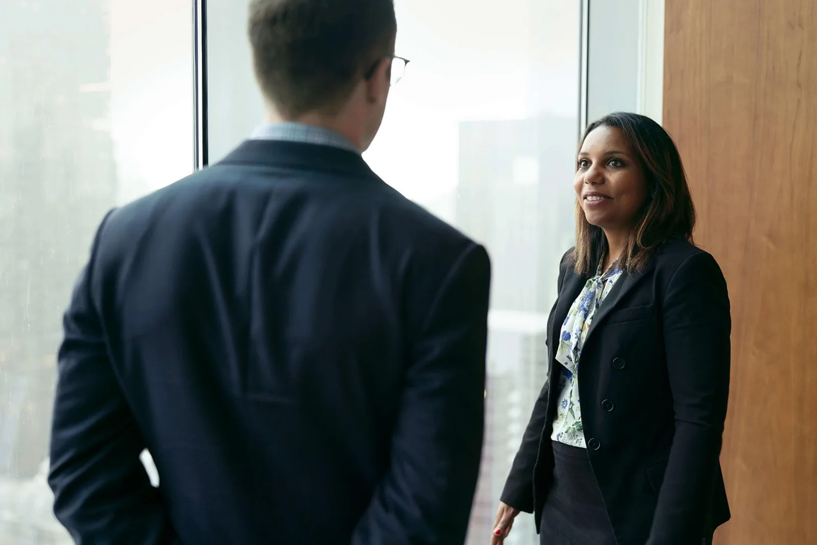 Woman hesitating in the office kitchen before speaking up: learning to talk about accomplishments