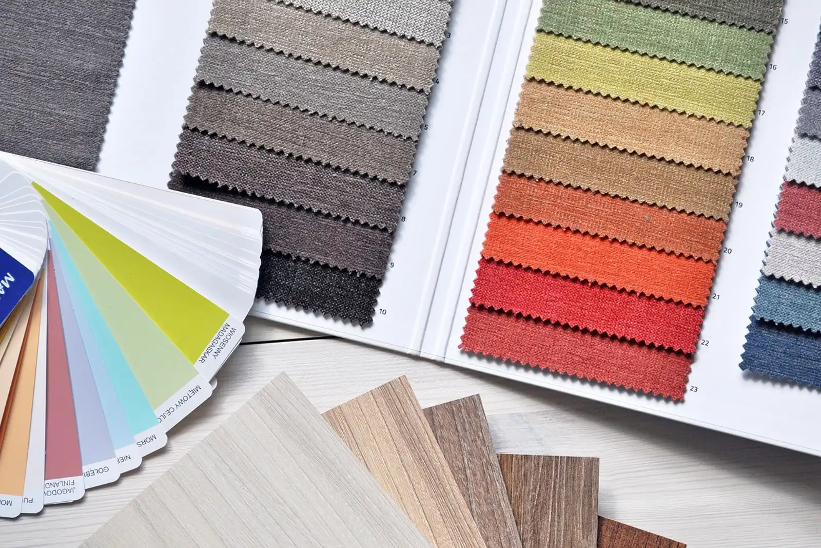 Fabric swatches, color swatches and wood samples on a table: a design side project as a way to reinvent yourself professionally at 50