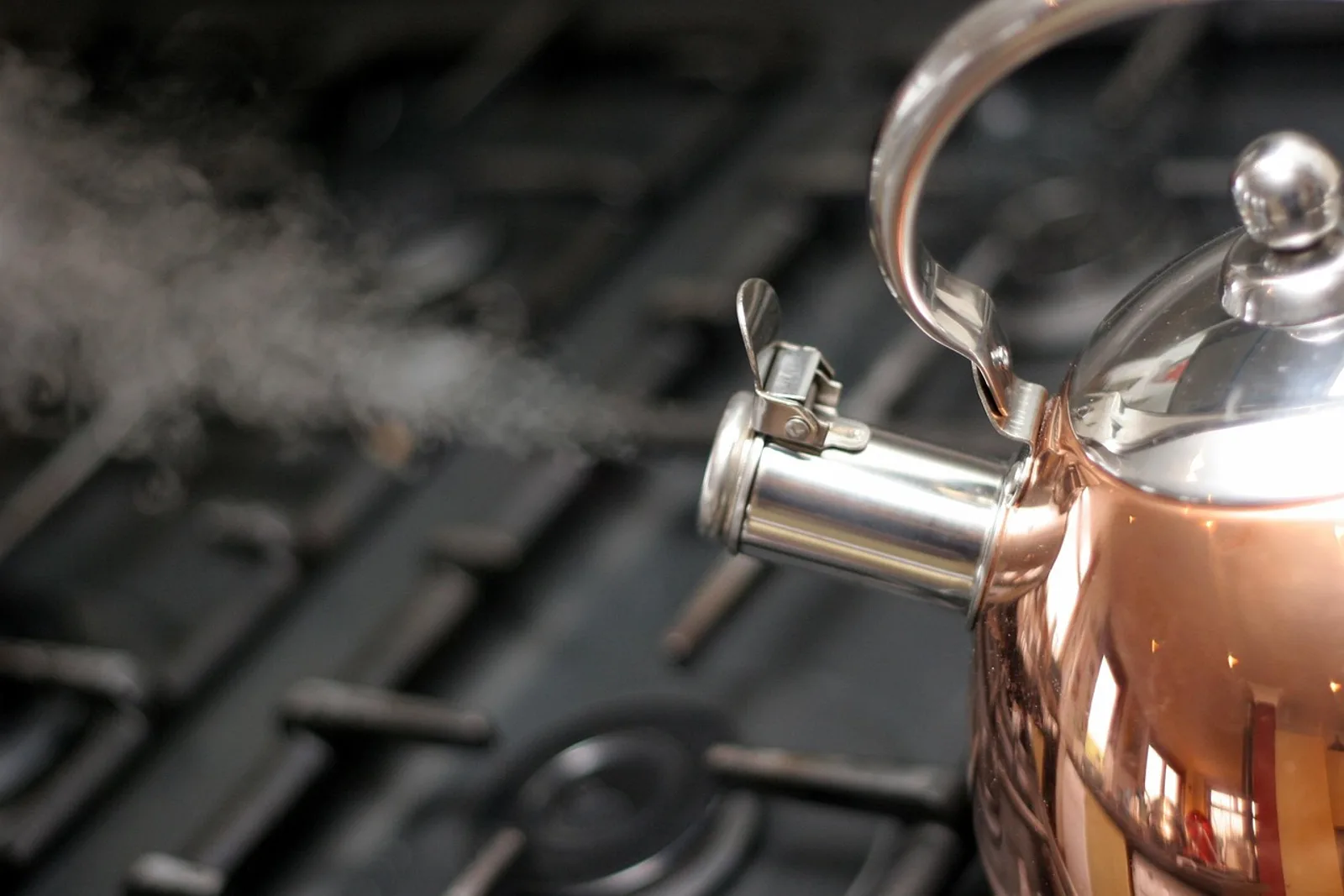 Steaming copper kettle on a gas stove: habit stacking uses the wait for boiling water as a trigger